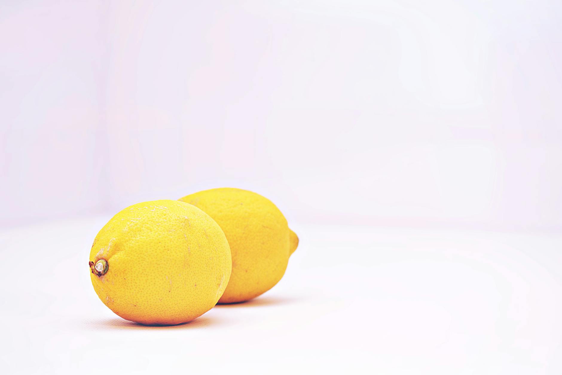Two vibrant lemons on a white background representing Hello Nancy lemon vibrators