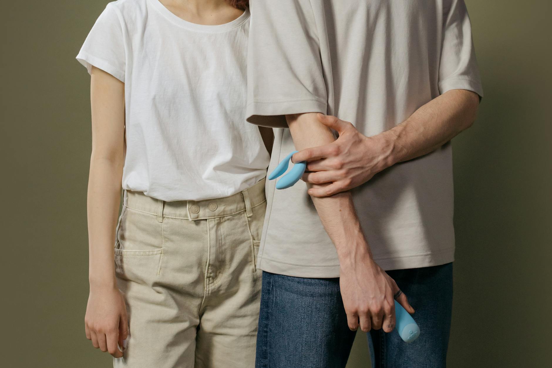 A young couple standing together indoors in comfortable communication